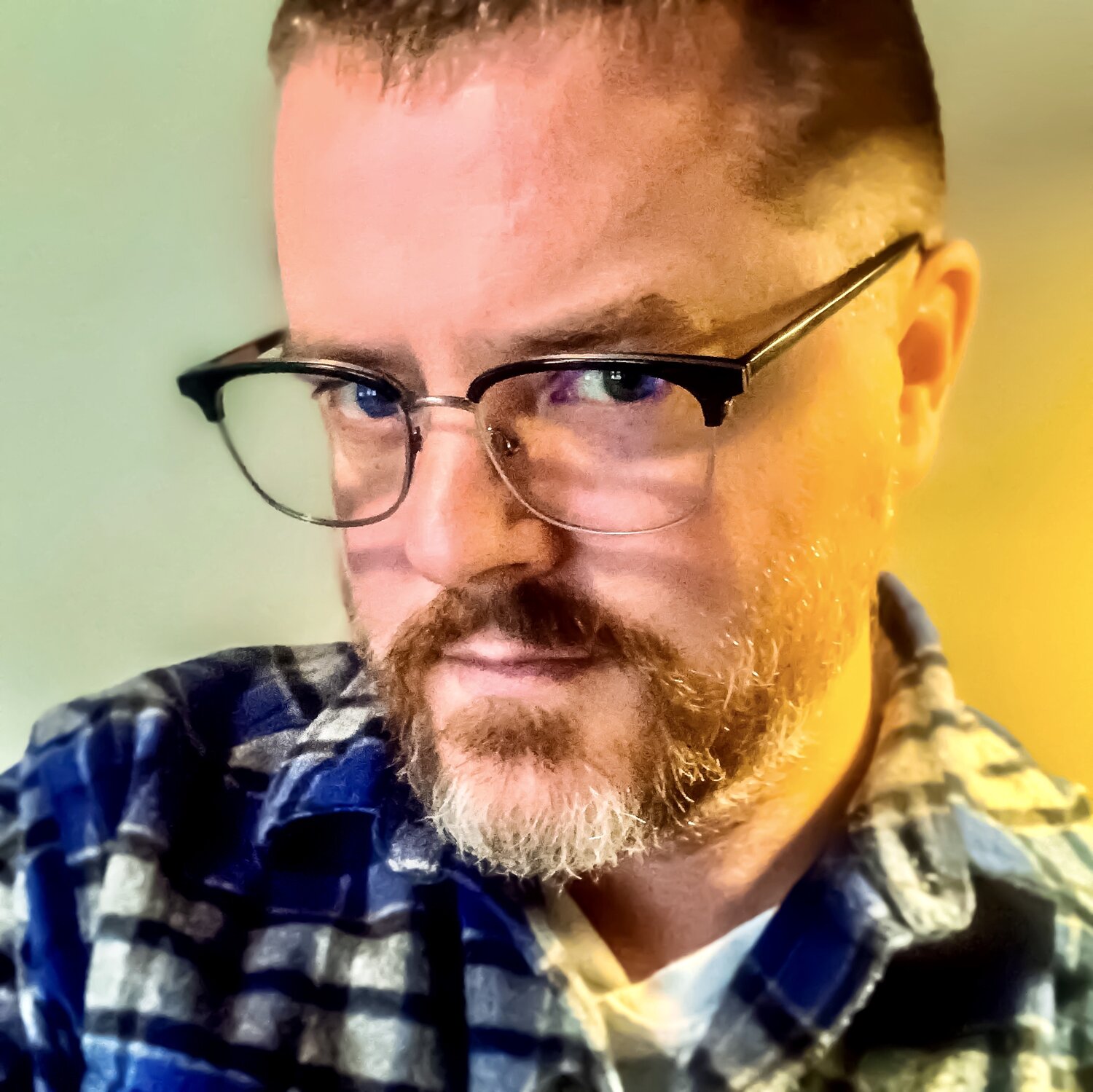 picture of Frederick Speers taken selfie stlye of a man with a blue plaid shirt, glasses, and facial hair